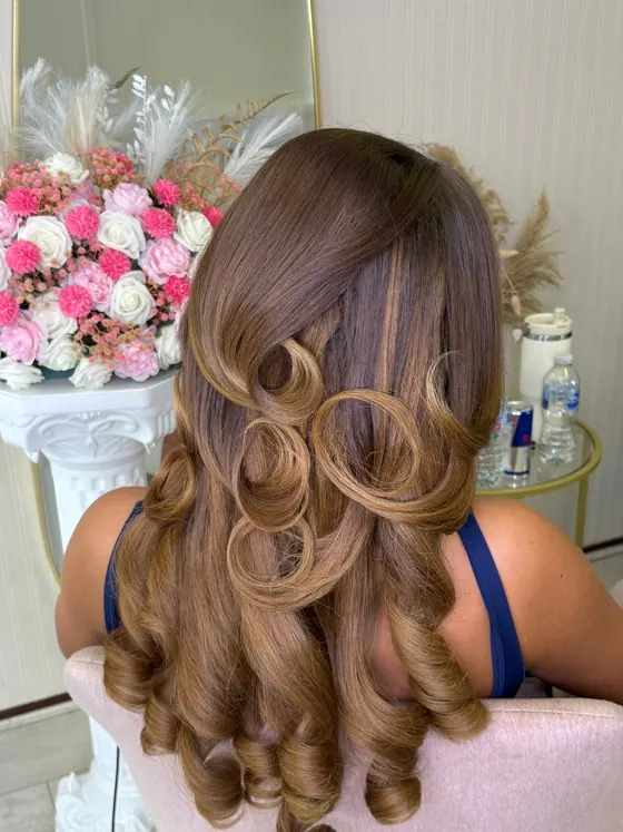 The same length of hair after styling, in full defined curls
