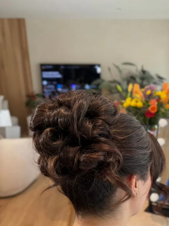 Dark curled updo styled in a client's front room