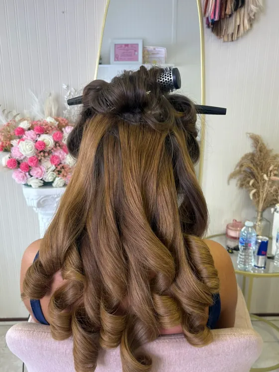 Bouncy blowdry worn half up, with defined curls through the ends