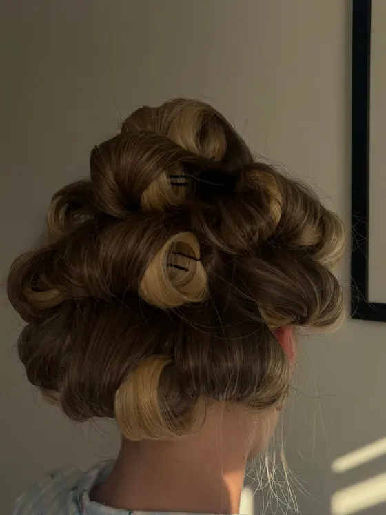 Close detail of dressed pin curls catching afternoon light