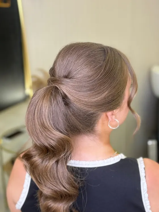 Sleek high ponytail with a deep wave through the length